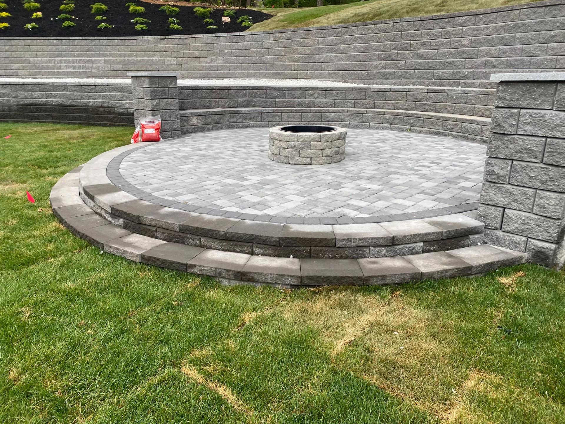 Natural stone patio with curved retaining wall