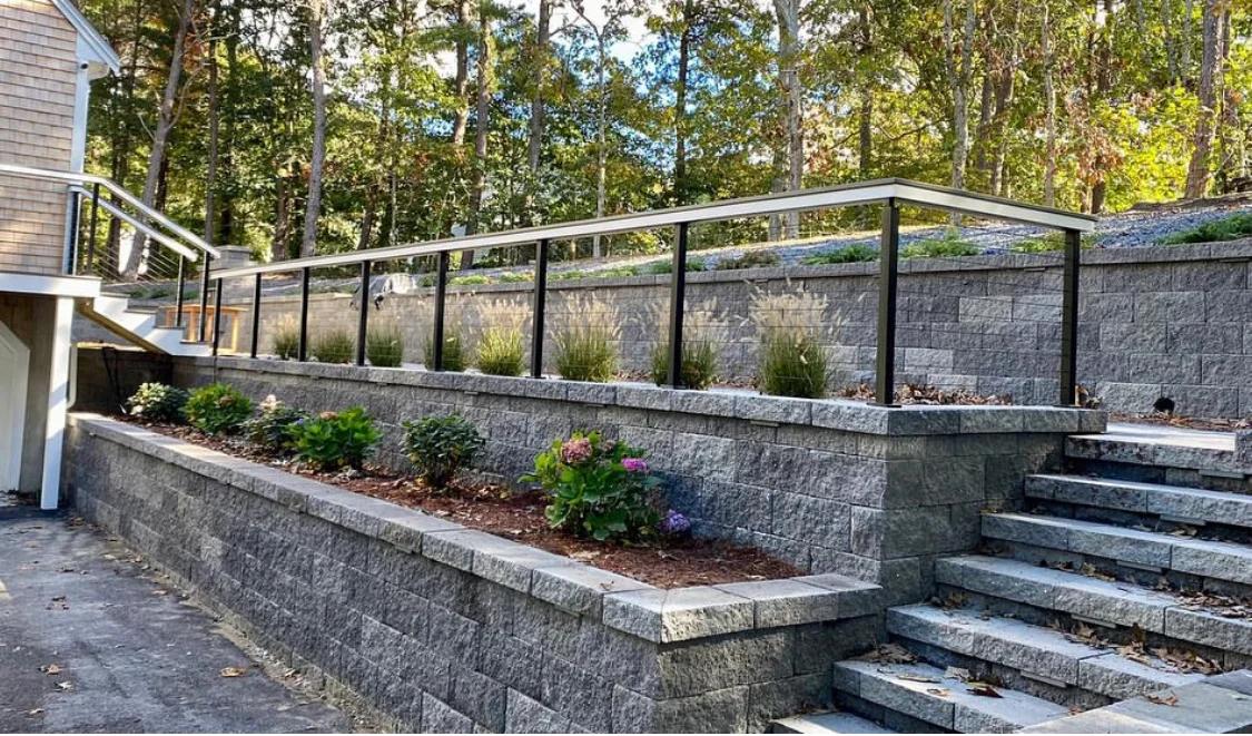 Stone retaining wall with accent lighting at golden hour
