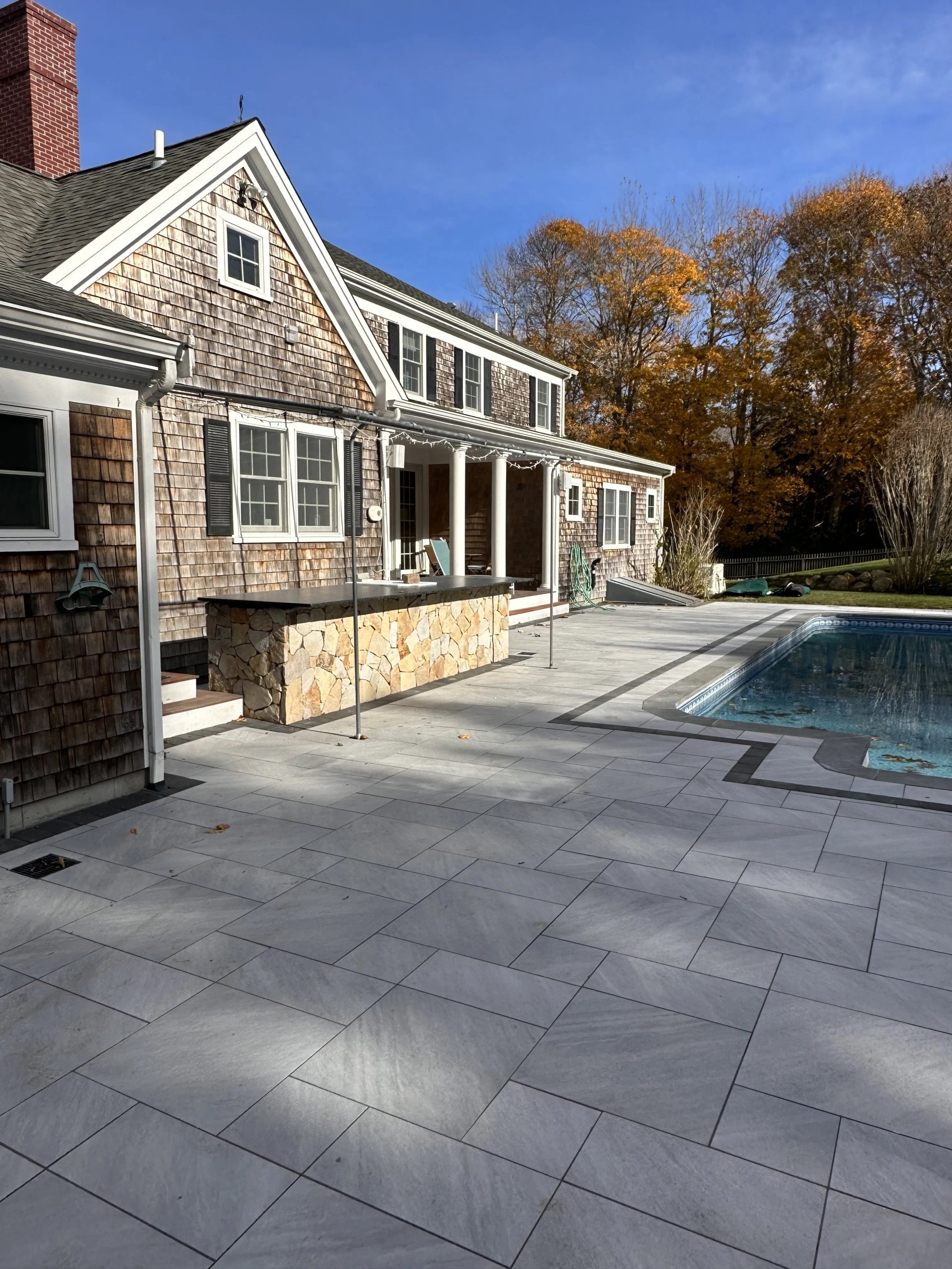 Patio with pool and outdoor kitchen in Plymouth Massachusetts