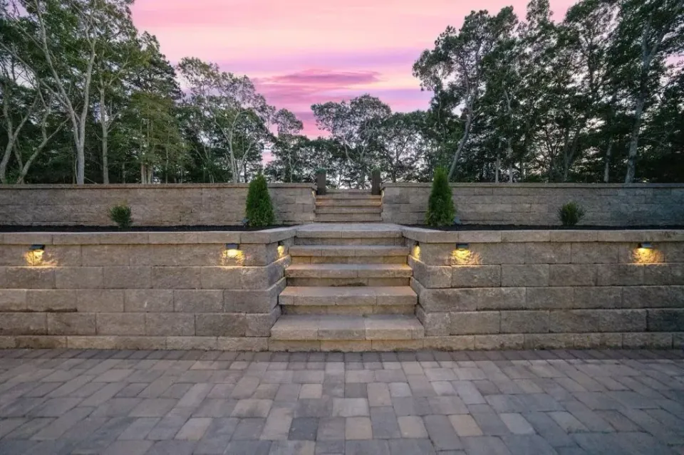 Illuminated stone steps and wall with path lighting in Dennis, MA